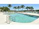 Enjoy the community pool with lounge chairs, shade umbrellas, and palm trees, perfect for relaxation and recreation at 27854 Arrowhead Cir, Punta Gorda, FL 33982