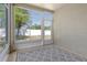 This sunroom features large windows with a view of the backyard, as well as neutral walls, and an area rug at 27854 Arrowhead Cir, Punta Gorda, FL 33982
