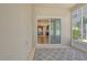 This sunroom features a view of the kitchen, with an area rug, large windows and neutral walls at 27854 Arrowhead Cir, Punta Gorda, FL 33982