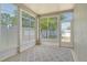 This sunny sunroom features large windows offering views of the backyard, complete with an area rug for added comfort at 27854 Arrowhead Cir, Punta Gorda, FL 33982