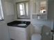 Bathroom featuring a white vanity with a dark countertop and ample storage space at 296 Milford St, Port Charlotte, FL 33953