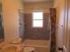 Bathroom featuring a tub and shower combination with tiled wall and floral curtain at 296 Milford St, Port Charlotte, FL 33953