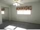 Bright bedroom with a ceiling fan, closet with mirrored doors, and a window with decorative valance at 296 Milford St, Port Charlotte, FL 33953