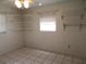 Bedroom with tiled floors, a ceiling fan and bright natural light at 296 Milford St, Port Charlotte, FL 33953