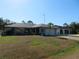 Attractive single-story home with a lush green lawn, complemented by a two-car garage at 296 Milford St, Port Charlotte, FL 33953