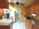 Well-lit kitchen with granite countertops, wooden cabinets, and modern appliances at 296 Milford St, Port Charlotte, FL 33953