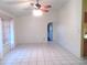 Bright living room with tile flooring, a ceiling fan, and natural light from large windows at 296 Milford St, Port Charlotte, FL 33953