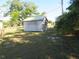 Outdoor storage shed with ladder on side, situated on lawn at 296 Milford St, Port Charlotte, FL 33953