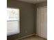 Bedroom with neutral walls, carpet flooring, window and closet with paneled doors at 3293 Cincinnati St, North Port, FL 34286