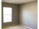 Neutral bedroom with light walls and carpet with a window allowing for natural light at 3293 Cincinnati St, North Port, FL 34286