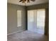 Spacious bedroom featuring neutral walls, carpet flooring, and sliding glass doors for ample natural light at 3293 Cincinnati St, North Port, FL 34286