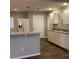 Well-lit kitchen boasts a breakfast bar, white cabinets, and essential appliances at 3293 Cincinnati St, North Port, FL 34286