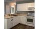 Efficient kitchen featuring updated appliances, white cabinets, and a dual-basin sink at 3293 Cincinnati St, North Port, FL 34286