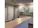 Practical kitchen with white cabinets, a breakfast bar, and stainless steel sink at 3293 Cincinnati St, North Port, FL 34286