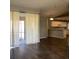 Open-concept living area with wood floors, sliding glass door, and a view into the kitchen at 3293 Cincinnati St, North Port, FL 34286