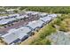Community aerial view showing townhomes with ample parking and an overgrown amenity area at 3300 Loveland Blvd # 2801, Punta Gorda, FL 33980