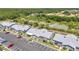 Community aerial view showing townhomes with ample parking and an overgrown amenity area at 3300 Loveland Blvd # 2801, Punta Gorda, FL 33980