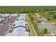 Community aerial view featuring well-maintained townhomes and parking, backed by lush greenery at 3300 Loveland Blvd # 2801, Punta Gorda, FL 33980