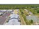 Community aerial view featuring well-maintained townhomes and parking, backed by lush greenery at 3300 Loveland Blvd # 2801, Punta Gorda, FL 33980