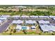 Aerial view of condos with a swimming pool and parking lot, surrounded by lush greenery in a sunny location at 3300 Loveland Blvd # 2801, Punta Gorda, FL 33980