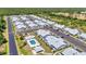 Drone shot of condominiums featuring a pool and parking spaces, nestled in a well-maintained, landscaped community at 3300 Loveland Blvd # 2801, Punta Gorda, FL 33980