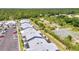 A community aerial view of residential townhomes with screened patios, parking and greenery at 3300 Loveland Blvd # 2801, Punta Gorda, FL 33980