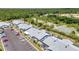Aerial view showcases the townhomes, parking and the greenery around the community at 3300 Loveland Blvd # 2801, Punta Gorda, FL 33980