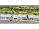Community aerial view showing blue townhomes with screened patios, parking, and landscaping at 3300 Loveland Blvd # 2801, Punta Gorda, FL 33980