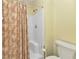 Bathroom featuring a shower, toilet, and patterned shower curtain at 3300 Loveland Blvd # 2801, Punta Gorda, FL 33980