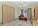 Bedroom features a large wardrobe, desk and chair, and an accent chair with access to the lanai at 3300 Loveland Blvd # 2801, Punta Gorda, FL 33980