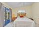 Bright bedroom with wooden bed frame, tile floors, and sliding glass doors to the patio at 3300 Loveland Blvd # 2801, Punta Gorda, FL 33980