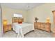 Charming bedroom features a wooden bed frame, tile flooring, and ample natural light at 3300 Loveland Blvd # 2801, Punta Gorda, FL 33980