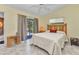 Well-lit bedroom features tile floors, a sliding glass door, and simple furnishings at 3300 Loveland Blvd # 2801, Punta Gorda, FL 33980