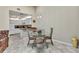 Bright dining area featuring a glass table, modern chairs, and access to the kitchen at 3300 Loveland Blvd # 2801, Punta Gorda, FL 33980