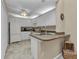 Well-lit kitchen with white cabinets, tile backsplash, and modern appliances at 3300 Loveland Blvd # 2801, Punta Gorda, FL 33980