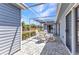 Covered and screened lanai featuring white rocking chairs, glass table and paver tile floor at 3300 Loveland Blvd # 2801, Punta Gorda, FL 33980