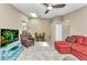 Open-concept living area with tile floors, a skylight, and comfortable seating arrangement at 3300 Loveland Blvd # 2801, Punta Gorda, FL 33980