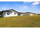 A wide shot of the back exterior of the house and backyard at 3315 Elkcam Blvd, Port Charlotte, FL 33952