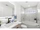 Modern bathroom featuring a vanity, integrated lighting, and a soaking tub with decorative tile surround at 3315 Elkcam Blvd, Port Charlotte, FL 33952