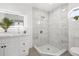 Renovated bathroom boasts a walk-in shower with marble tile and a stylish vanity at 3315 Elkcam Blvd, Port Charlotte, FL 33952