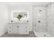 This bathroom features a double vanity with lighted mirror and a glass-enclosed shower at 3315 Elkcam Blvd, Port Charlotte, FL 33952