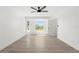 This bedroom features wood-look tile floors, a ceiling fan and lots of natural light at 3315 Elkcam Blvd, Port Charlotte, FL 33952