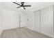 This bedroom features wood-look tile floors, a ceiling fan and a closet at 3315 Elkcam Blvd, Port Charlotte, FL 33952