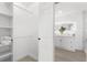 Walk-in closet leading to a dual sink bathroom with marble countertops, modern lights and large walk-in shower at 3315 Elkcam Blvd, Port Charlotte, FL 33952