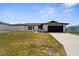 Charming single-story home featuring a dark brown roof and garage door with a well-maintained lawn at 3315 Elkcam Blvd, Port Charlotte, FL 33952
