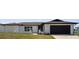 Charming single-story home with white exterior, black door/trim and well-manicured lawn at 3315 Elkcam Blvd, Port Charlotte, FL 33952