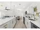 Spacious kitchen with white cabinets, stainless steel appliances, and an open layout to the living room at 3315 Elkcam Blvd, Port Charlotte, FL 33952