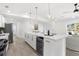 Bright, open kitchen with a large island, pendant lighting, and stainless steel appliances at 3315 Elkcam Blvd, Port Charlotte, FL 33952