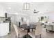 Open-concept living area with modern light fixtures and a dining table with chairs at 3315 Elkcam Blvd, Port Charlotte, FL 33952