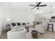 Bright living room with modern furnishings, a ceiling fan, and an open layout to the dining area at 3315 Elkcam Blvd, Port Charlotte, FL 33952